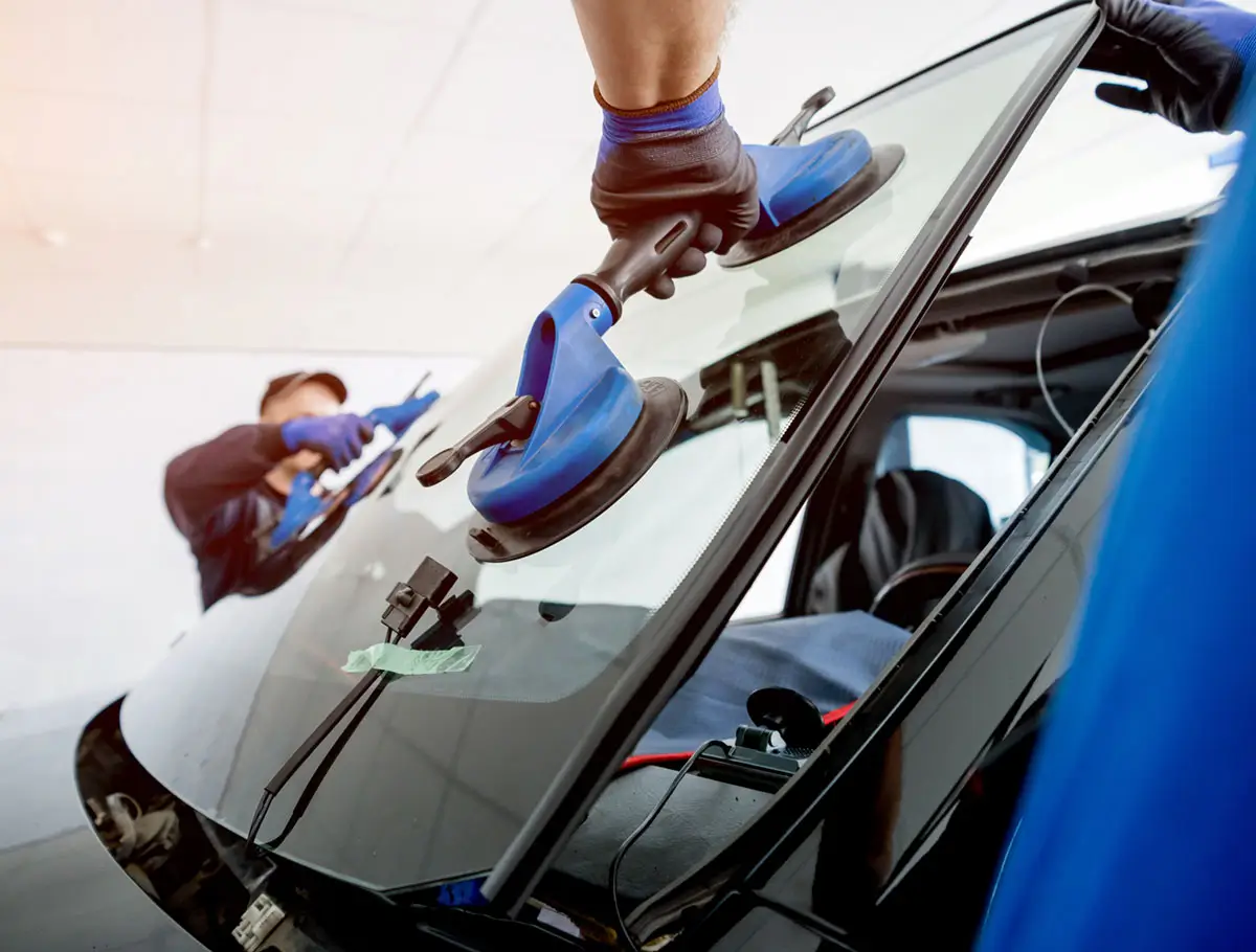 Trademark Glassworks techs installing a new windshield Trademark Glassworks techs installing a new windshield