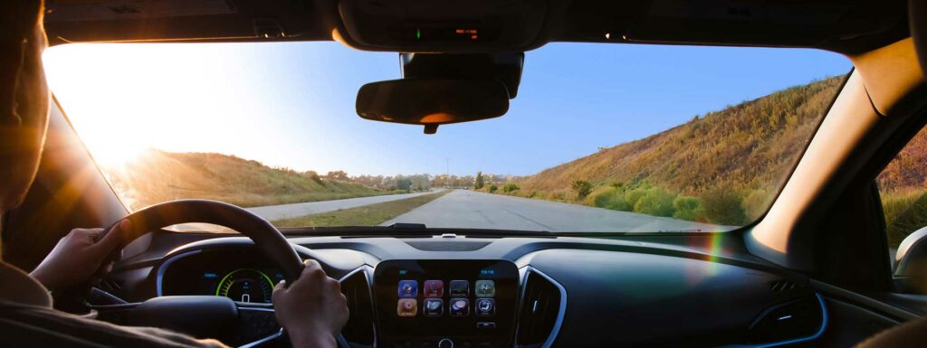 guy looking through a windshield of a car