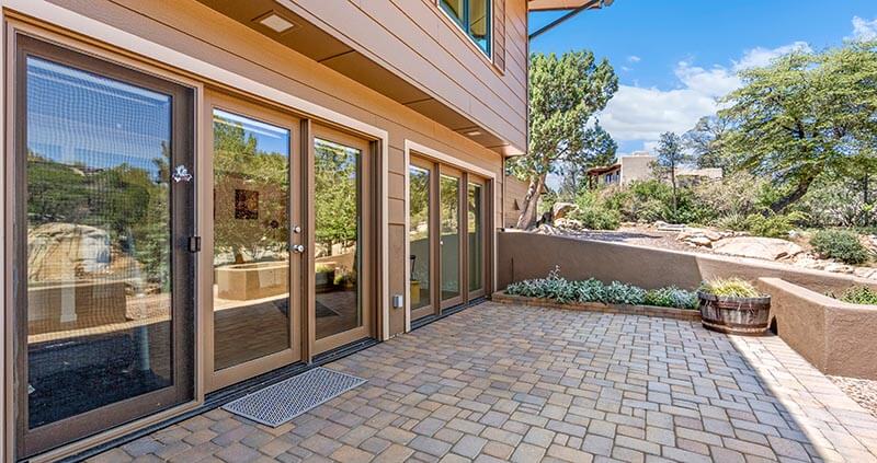 house with a patio and sliding glass doors for access